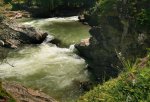 Lynx Creek Provincial Recreation Area, Alberta, Canada. High spring runoff over the falls after the bend in the river.