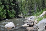 Click to enlarge Racehorse Creek Provincial Recreation Area, Alberta, Canada. A bridge crossing opens the opposite bank for walks and mountain biking.