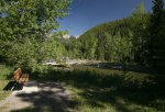 Dutch Creek Provincial Recreation Area, Alberta, Canada. A bench beside Dutch Creek on a walking path paralleling the river.