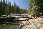 Livingstone Falls Provincial Recreation Area, Alberta, Canada. This bridge from the campground crosses the waterfall area to an island surrounded by the Livingstone River.