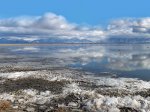 Click to enlarge Antelope Island State Park, Utah, United States. Salt Lake. Mountains in the clouds, piling up fragments of on the shore of ice caused by strong winds